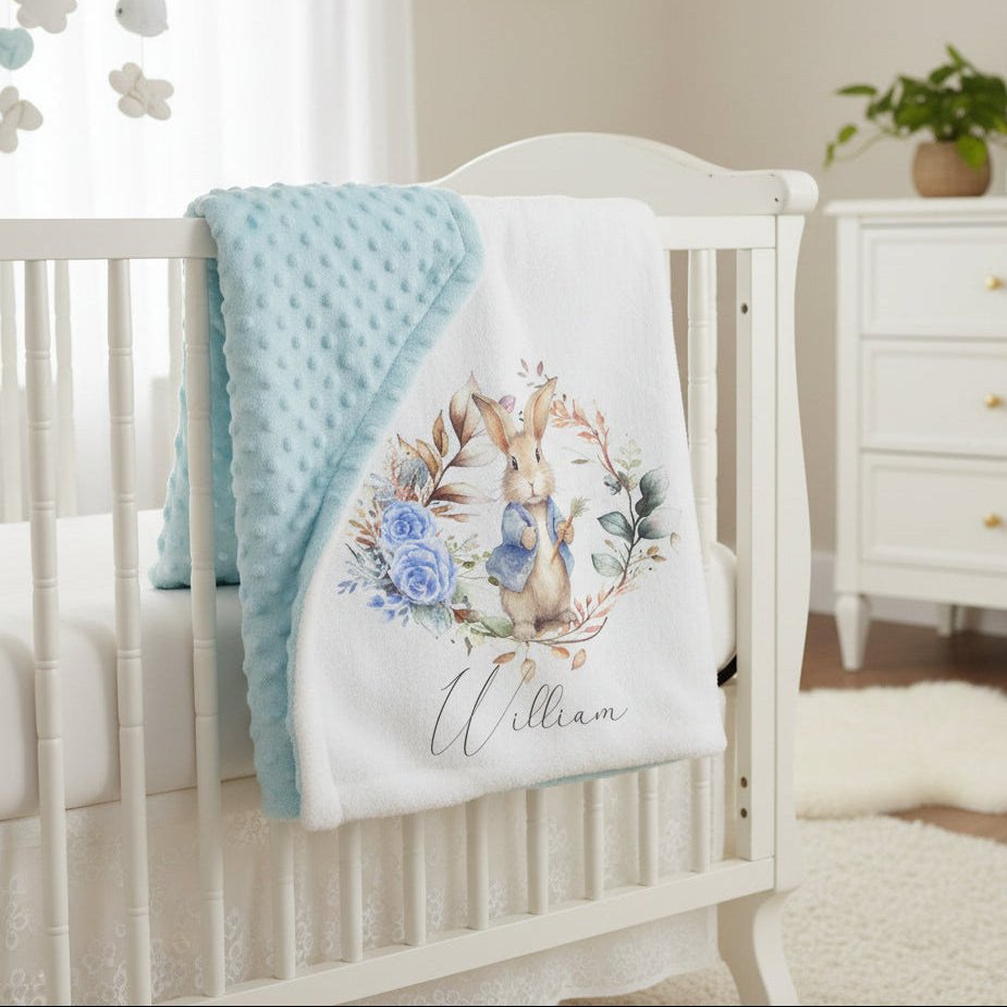 Crib with personalized blanket featuring a rabbit design in a nursery setting