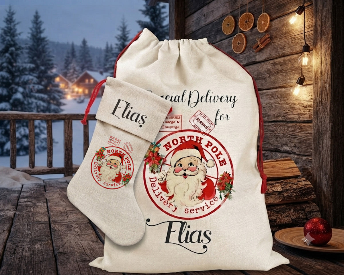 A personalized Christmas Santa sack and matching stocking set displayed on a rustic wooden porch. The cream-colored fabric sack features a red circular stamp design with an illustration of Santa Claus and the text 'North Pole Delivery Services' and the name 'Elias'.