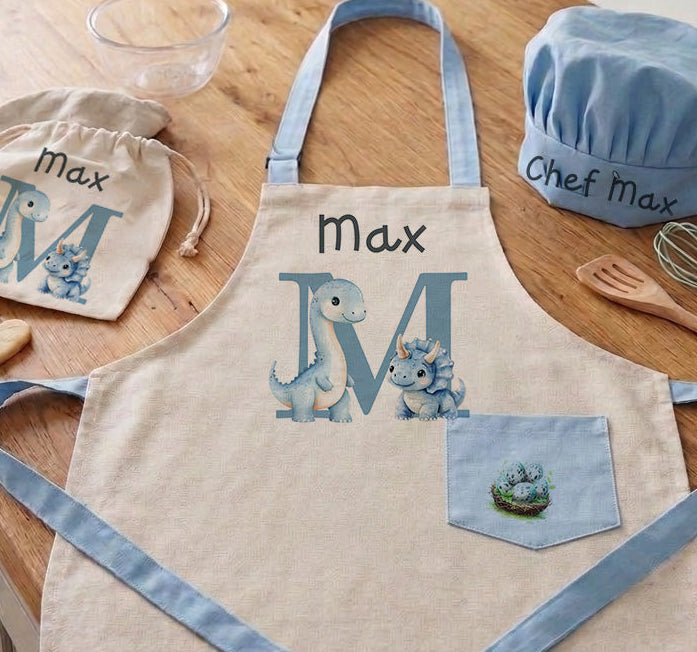 Children's apron and chef hat set with 'Max' on a kitchen counter