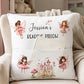 A personalized white reading pillow with fairy and castle illustrations, resting on a beige armchair with a knitted blanket. The pillow features the text 'Jessica's READING PILLOW' and includes a front pocket holding a book.