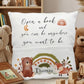 A personalized white throw pillow featuring a woodland theme with the quote 'Open a book and you can be anywhere you want to be' and the name 'Thomas'. The pillow is decorated with illustrations of a brown bear, a fox, a small hedgehog, a rainbow, and leaves.