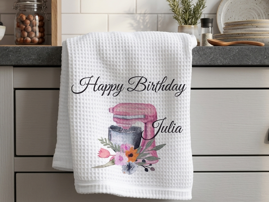 Personalised waffle weave birthday tea towel featuring a pink watercolour stand mixer with flowers and the name Julia.